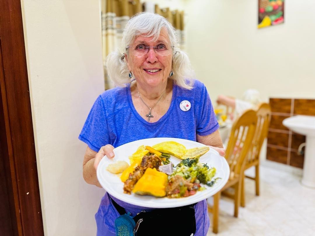 Guests sharing a home-cooked Rwandan meal
